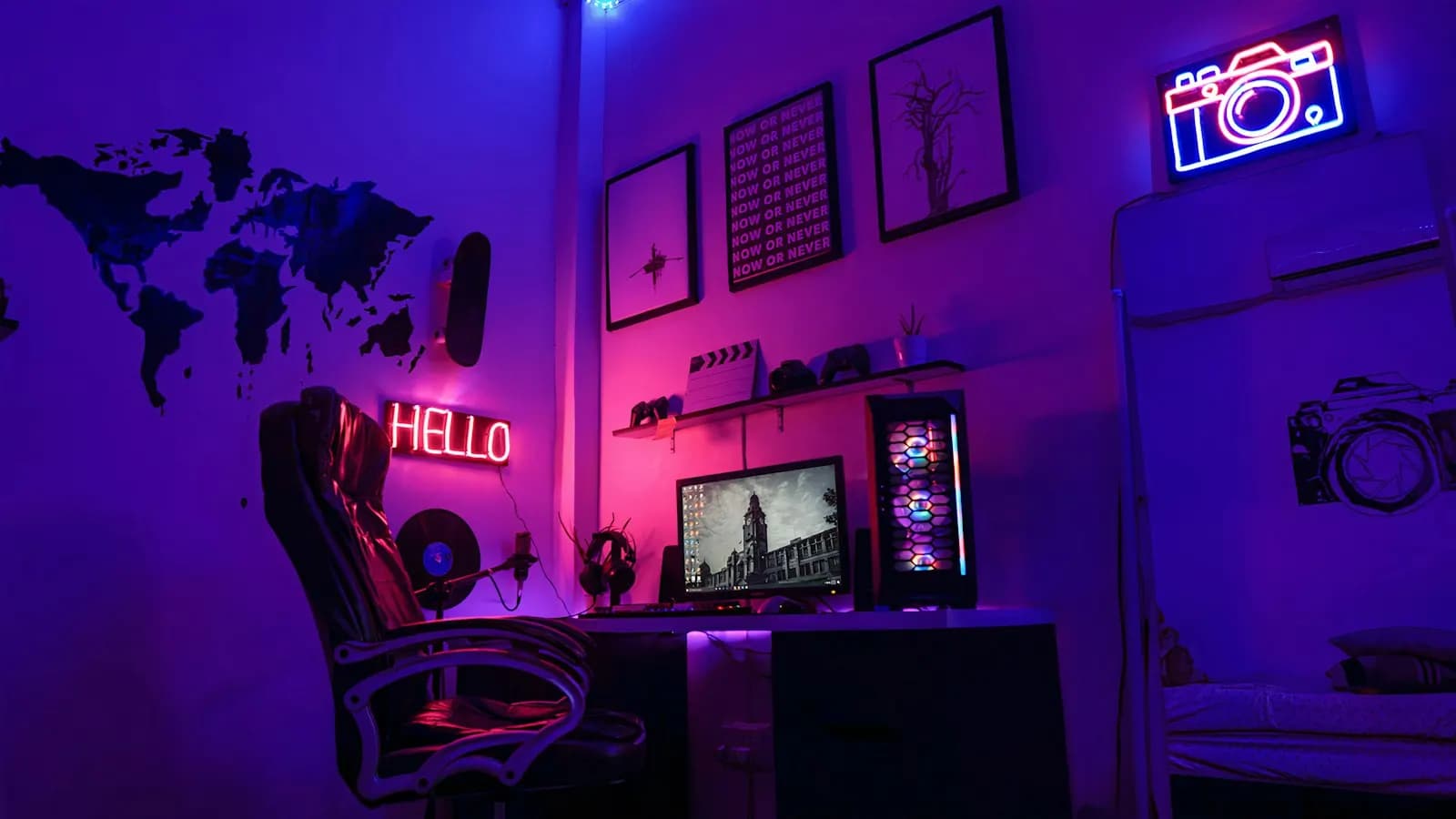 A streaming setup with monitors lit in purple and blue